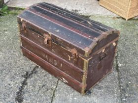 A large early 20th century dome top trunk with DVD’s.
