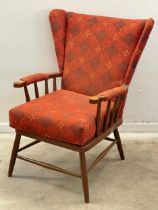 A vintage Ercol style wingback armchair.