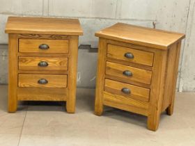 A pair of heavy oak bedsides with 3 drawers. 55x40.5x65.5cm