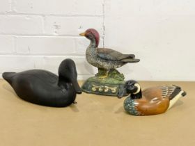 A cast iron door stop and 2 wooden ducks. 37cm