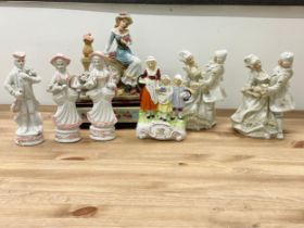 A collection of vintage pottery figurines and a figurine mantle clock. Clock measures 22x12x28cm