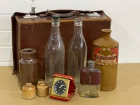 A collection of vintage stone and glass bottles, flask, leather case etc.