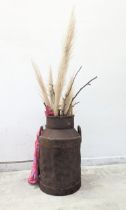 A milk churn converted into plant pot