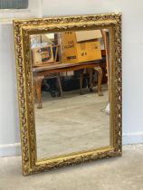 An ornate plastic framed mirror. 69x83cm