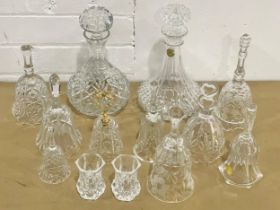 A collection of crystal bells and 2 decanters.