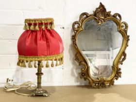 A vintage gilt framed mirror and a brass table lamp. Mirror 33x46cm