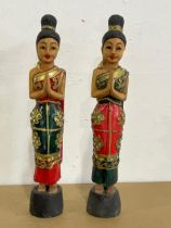 A pair of wooden figures. 39cm