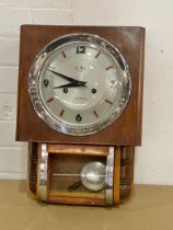 A White Mountain wall clock. With pendulum. 30x43cm