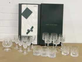 A quantity of crystal drinking glasses and Irish linen in box.