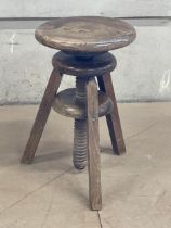 A vintage adjustable artists stool