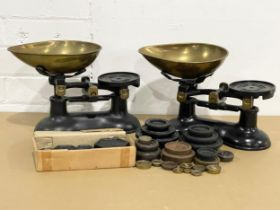 A pair of vintage cast iron Victor kitchen scales with weights.