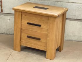 A large heavy oak bedside with 2 drawers.65x44x63.5cm