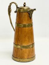 A large late 19th/early 20th century oak brass bound pitcher. Circa 1900. 18x29.5cm