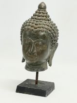 A late 19th/early 20th century Tibetan Bronze bust on stand. 26cm