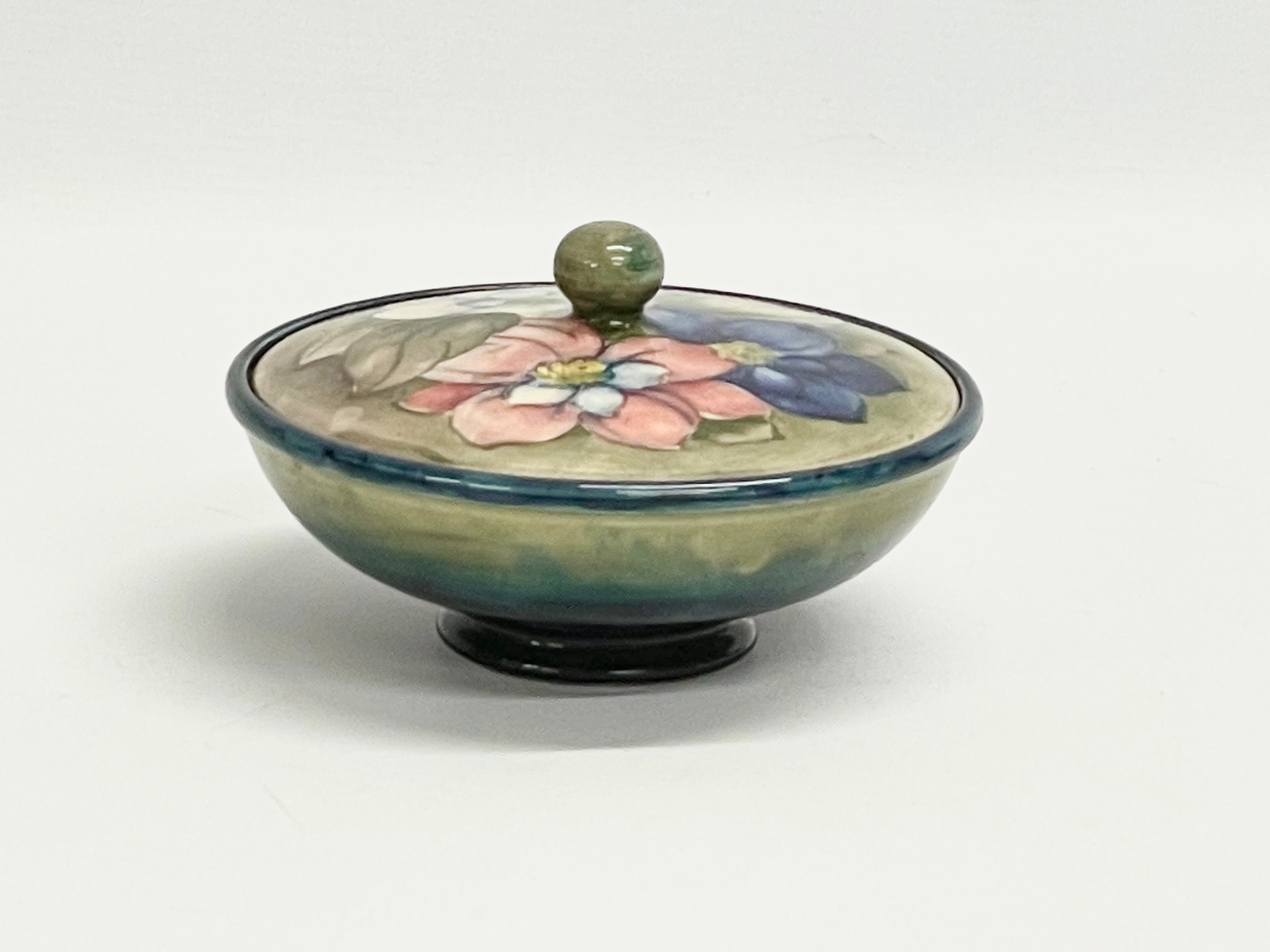 A signed William Moorcroft ‘Clematis’ lidded powder bowl. Pottery to H. M. The Queen. 16x9cm - Image 6 of 9