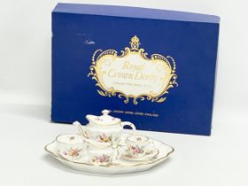 A Royal Crown Derby ‘Derby Posies’ miniature porcelain tea set in box. Tray measures 22x17cm.