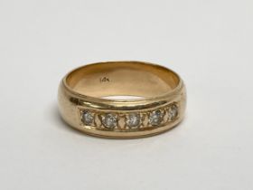 A 14k gold and diamond ring. 7.23 grams. Size U.