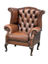 A deep button leather wingback armchair