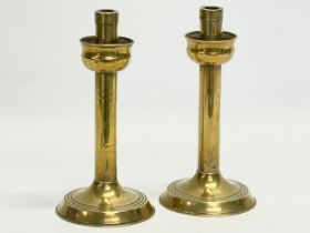 A pair of early 20th century brass candlesticks. 23cm