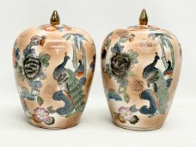 A pair of Chinese porcelain urns with lids. 18x26cm