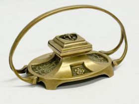 A Victorian brass inkwell. 20x10x12