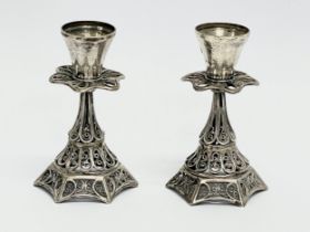 A pair of ornate silver candlesticks. 60.7 grams. 7.5cm