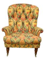 A 19th century style Marlborough overstuffed button back armchair on brass cup casters. 84x80x102cm