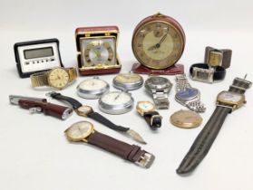 A collection of watches, travel clocks, stopwatches, etc