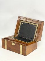 A Victorian walnut brass bound writing slope. Closed 35x24x17cm. Open 49.5cm