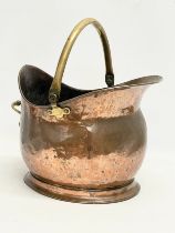 A Victorian copper and brass coal scuttle. 19x35x26cm