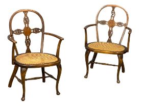 A pair of early 20th century armchairs with bergere seats.
