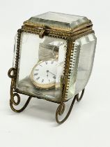 A French gold watch stamped K18, in a late 19th century bevelled glass carriage case.