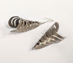 A pair of ornate silver earrings