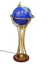 A rotating brass light up floor globe. 101cm