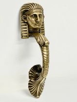 A Victorian brass Egyptian Revival door knocker. 25cm