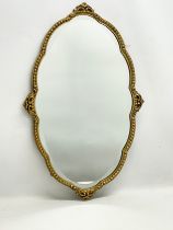 A vintage brass framed bevelled mirror. 46.5x74cm
