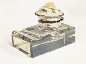 A silver and cut glass inkwell with porcelain rose decoration.