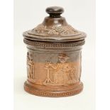 A Doulton Lambeth stoneware tobacco jar with lid. 11x14cm