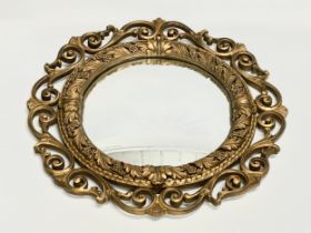 A vintage ornate gilt framed convex mirror by Atsonea. 58cm