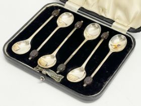 A set of 6 silver spoons in case. Stamped EV. Sheffield. 57.9 grams.