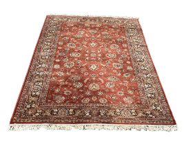 A large Middle Eastern style rug. 249x367cm