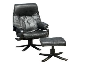 A Danish Mid Century leather swivel armchair with stool. Unico. Denmark.