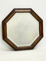 An early 20th century oak framed bevelled mirror. 43.5cm