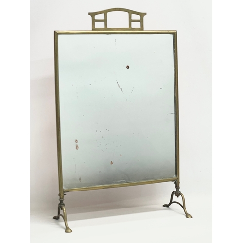 An Edwardian brass mirrored firescreen. 40x17x63.4cm