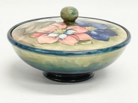A signed William Moorcroft ‘Clematis’ lidded powder bowl. Pottery to H. M. The Queen. 16x9cm