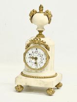 A late 19th century French marble mantle clock with brass mounts and enamel face. 11x11x23.5cm