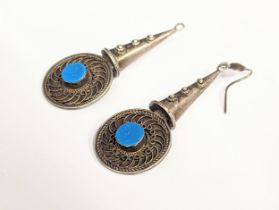 A pair of ornate silver earrings