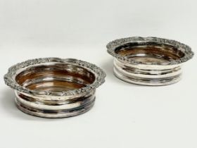 A pair of ornate silver platter wine coasters. 16x4.5cm