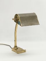 A large good quality brass desk lamp with leather shade. 22x29x40.5cm