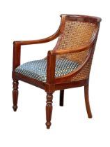 A 19th century style mahogany and bergere armchair.